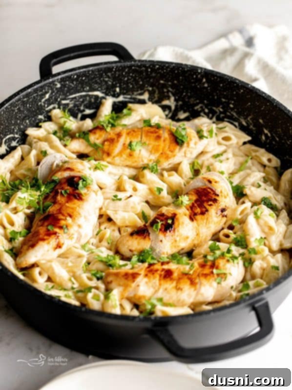 A close-up of a bowl of Creamy Chicken Penne Pasta, ready to eat.
