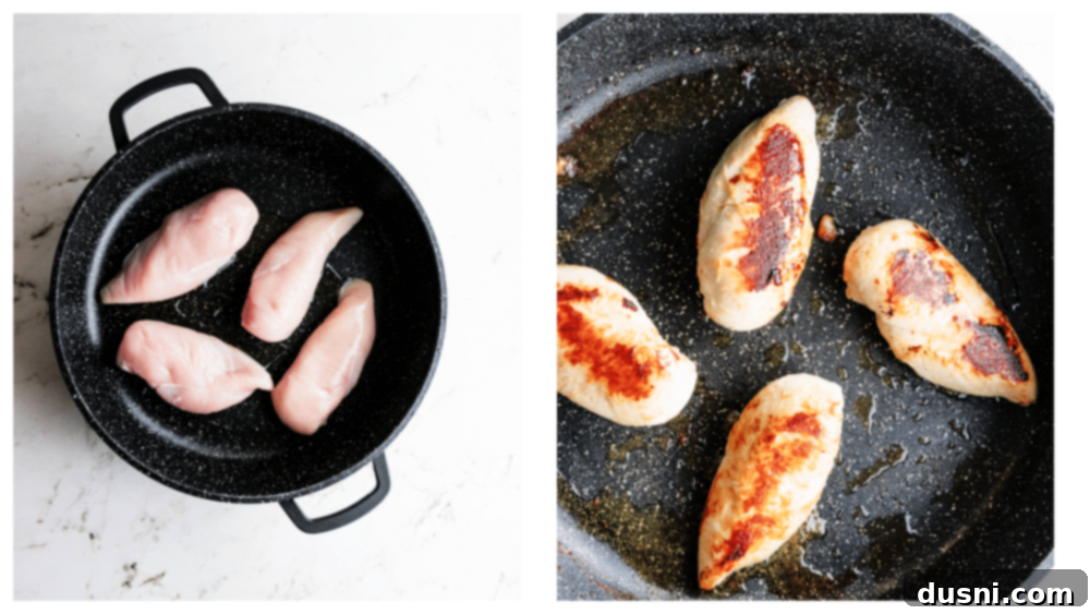Chicken breasts being seasoned with salt and pepper on a cutting board.