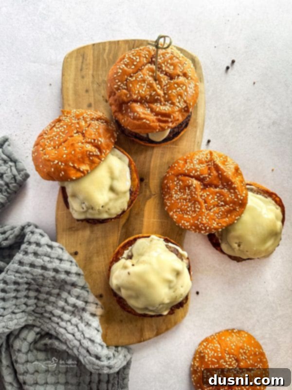 Signature Mushroom Swiss Burger 15 Several Mushroom Swiss Burgers arranged on a platter, ready to be served.
