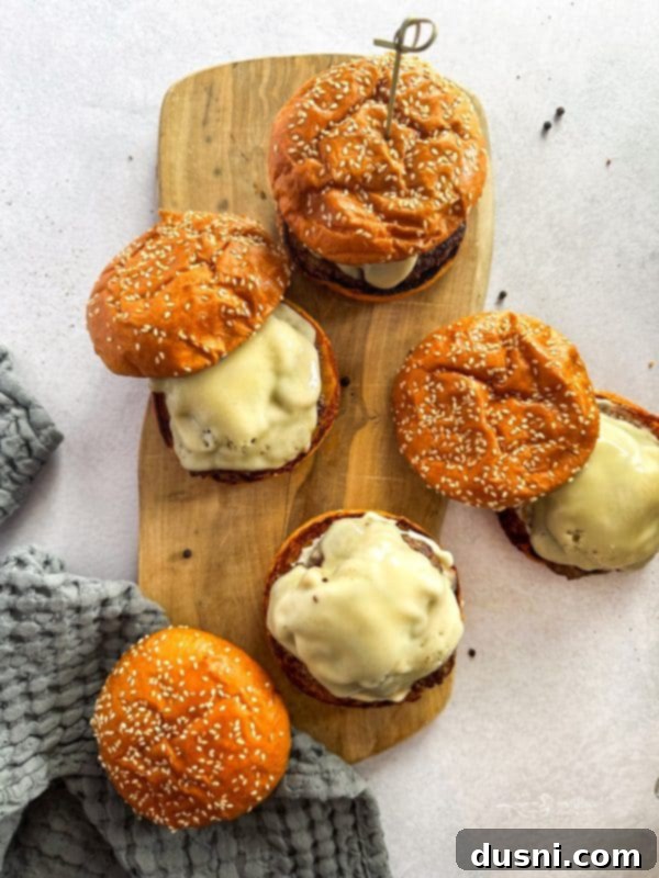 Signature Mushroom Swiss Burger 5 Close-up shot of raw ground beef patties seasoned with salt and pepper.