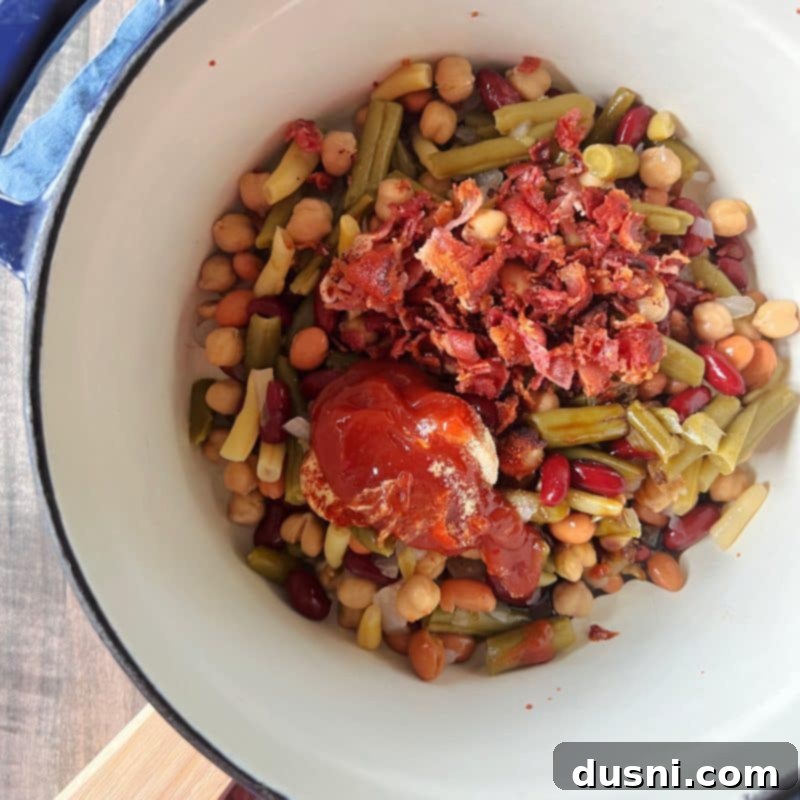 Hearty Five-Bean Bake 5 Combining ingredients for Five Bean Baked Beans in a bowl