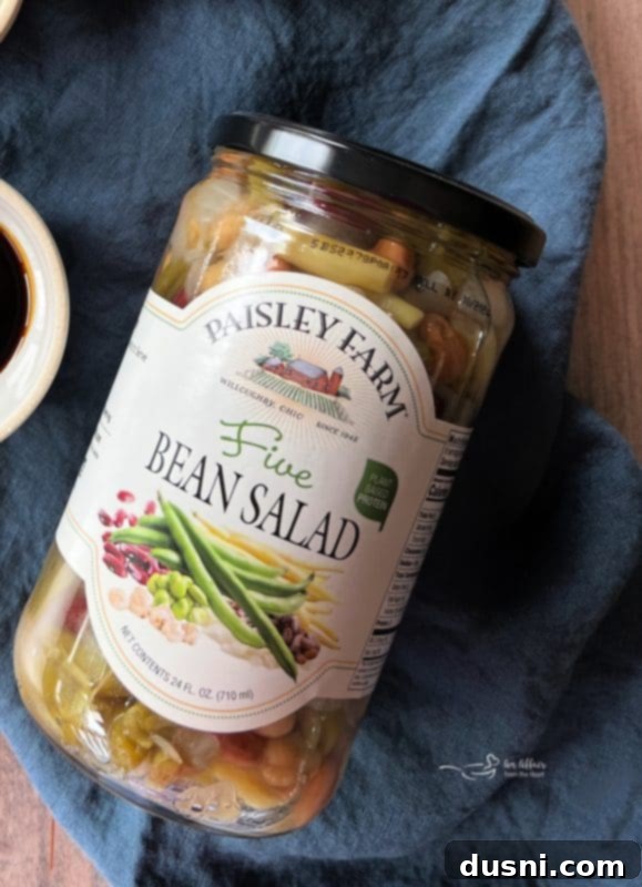 Hearty Five-Bean Bake 9 Jar of Paisley Farm Five Bean Salad next to a bowl of baked beans