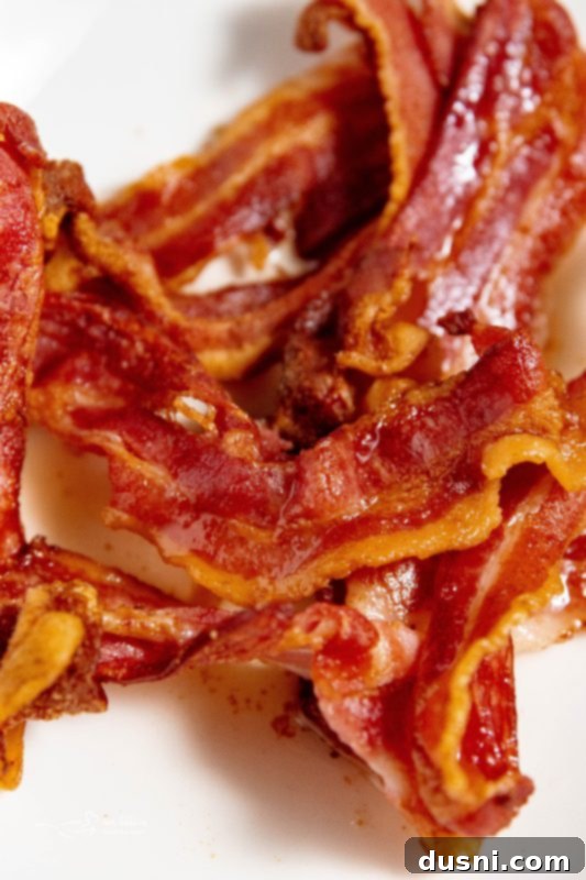 Perfectly Crispy Air Fryer Bacon 3 Crispy Air Fryer Bacon on a white plate