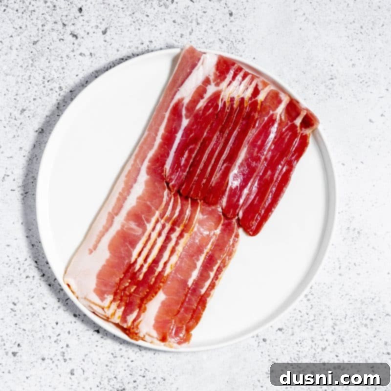 Perfectly Crispy Air Fryer Bacon 6 Crispy Air Fryer Bacon close up in an air fryer basket