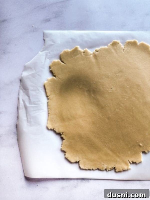 Buttery Shortbread Ice Cream Cookie Cake 10 Forming the shortbread dough into a disc between parchment paper.