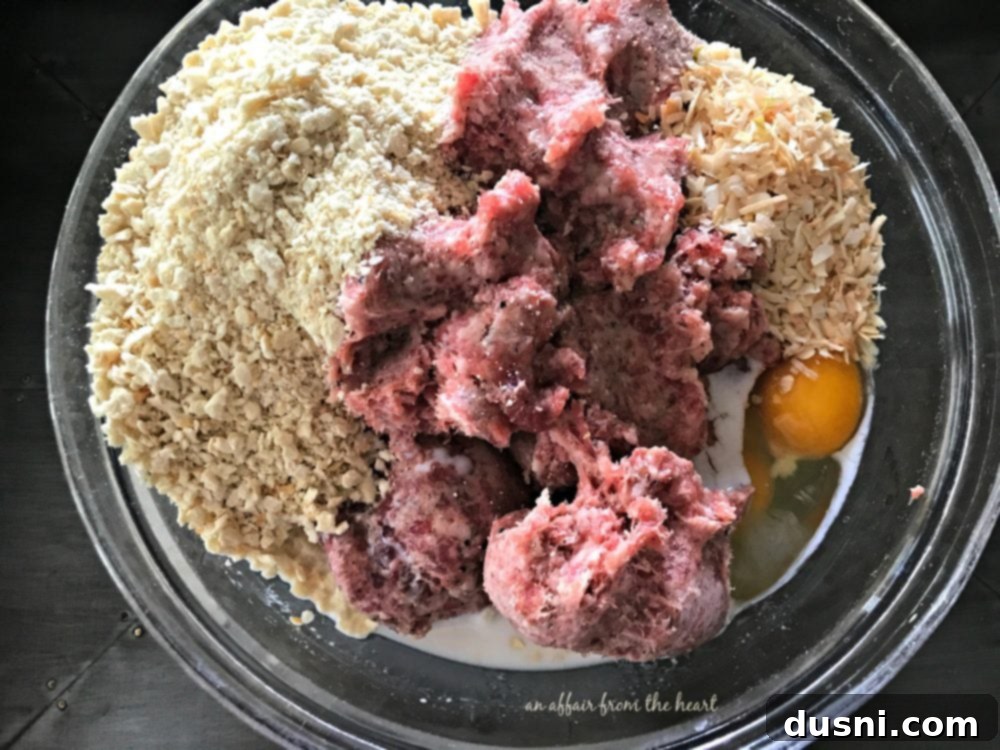 Moms Hearty Pork Sausage Meatloaf 5 Meatloaf ingredients: pork sausage, egg, onion, cracker crumbs, milk in a bowl