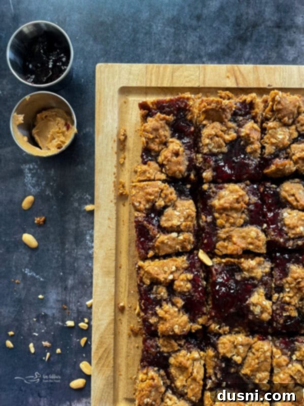 Close-up of a PB&J Oatmeal Cookie Bar, highlighting the chewy texture and grape jelly swirl