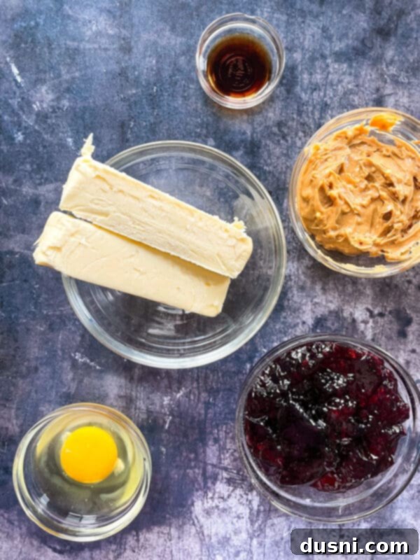 A selection of dry ingredients for PB&J Oatmeal Cookie Bars: flour, oats, brown sugar, baking soda in bowls