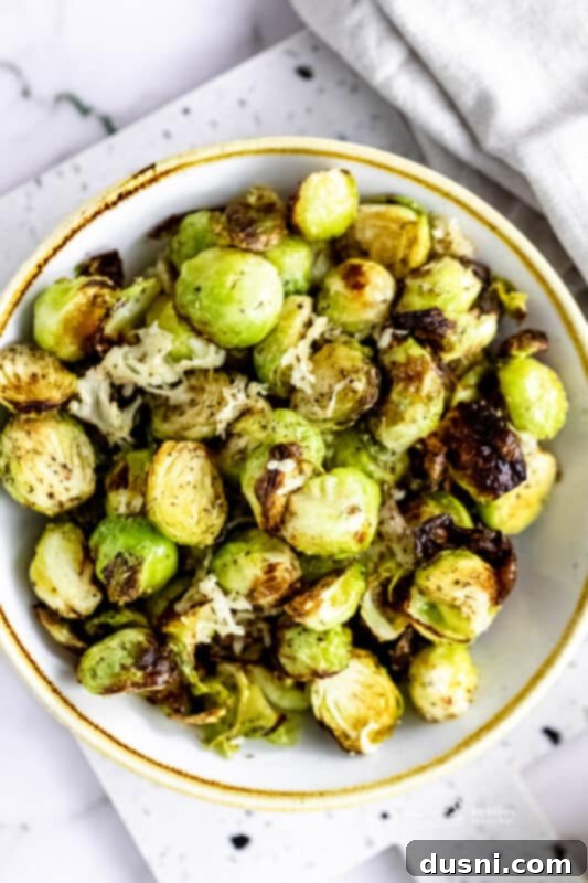 Crispy Air Fryer Zucchini Fries 18 Air Fryer Brussels sprouts in a white serving bowl.