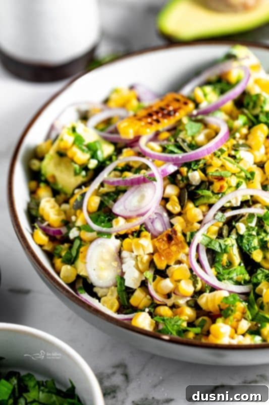 Close-up of the Grilled Corn and Avocado Salad being served in a bowl