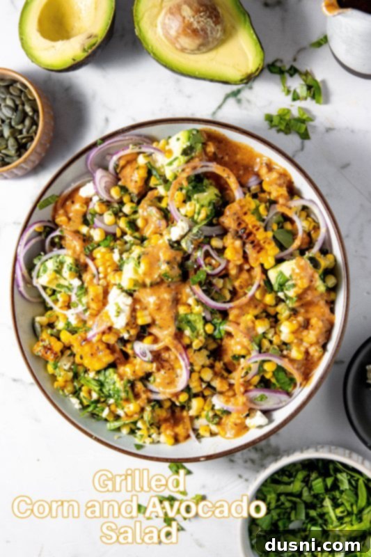 A large serving bowl of Grilled Corn and Avocado Salad, ready to be enjoyed
