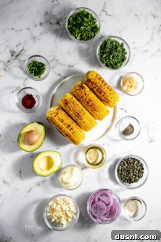 A bowl of fresh ingredients for Grilled Corn and Avocado Salad before mixing