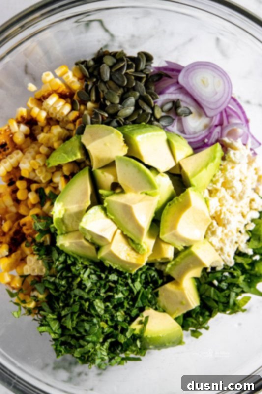 Step 4: Adding cubed avocado and chopped herbs to the salad