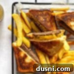 Close up of Dunker burgers and fries in a clear serving dish.