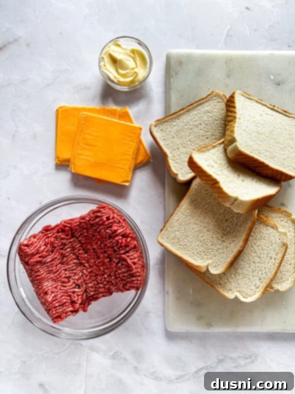 Ingredients for Au Jus: butter, flour, beef stock, Worcestershire sauce, onion powder, salt, and pepper arranged on a counter.