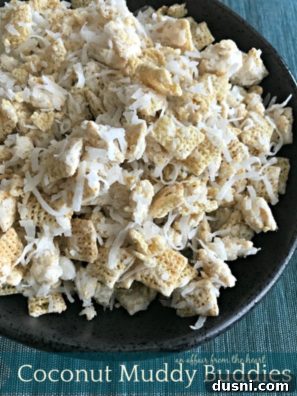 A bowl of freshly made Coconut Muddy Buddies, ready to be enjoyed