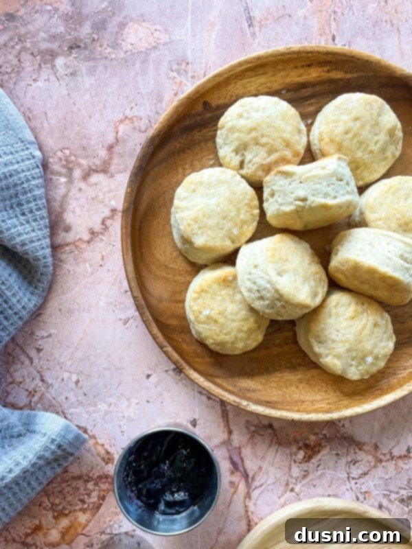 Golden Buttermilk Clouds 2 Golden-brown Old Fashioned Buttermilk Biscuits stacked on a plate
