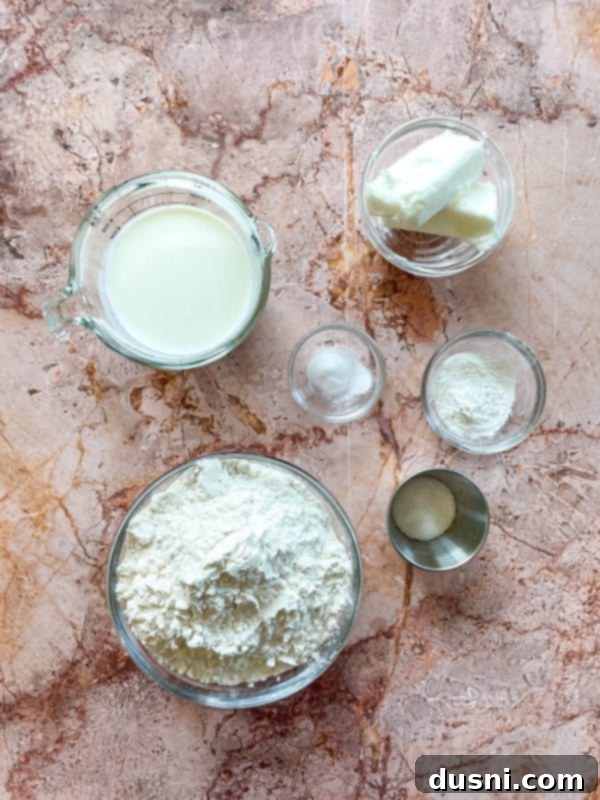 Golden Buttermilk Clouds 5 Batch of freshly baked buttermilk biscuits on a wooden board