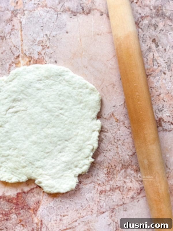 Golden Buttermilk Clouds 8 Buttermilk being stirred into biscuit dough with a fork