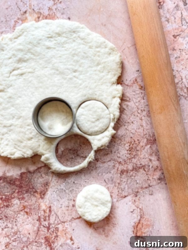 Golden Buttermilk Clouds 9 Biscuit dough being rolled out on a floured surface