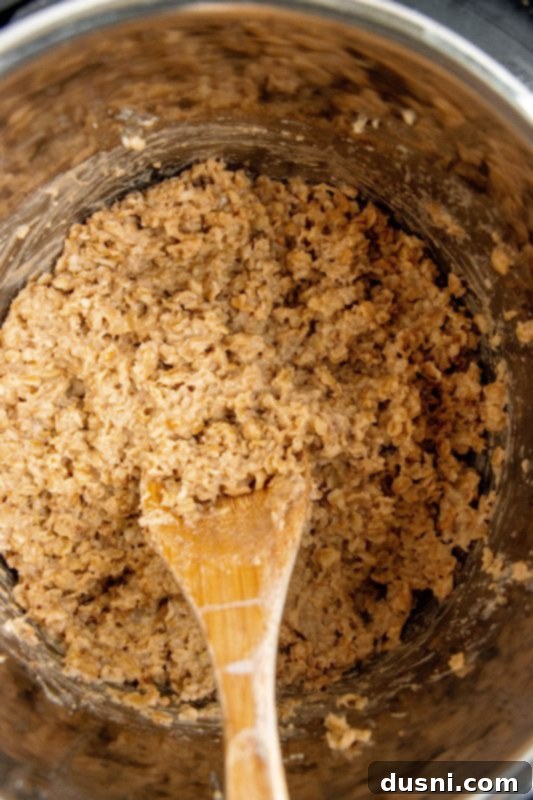 Instant Pot lid being carefully removed after cooking oatmeal.