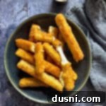 Mozzarella sticks on a green plate.