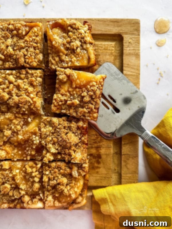 Assembled Apple Pie Crumb Bars in a baking pan, ready to go into the oven