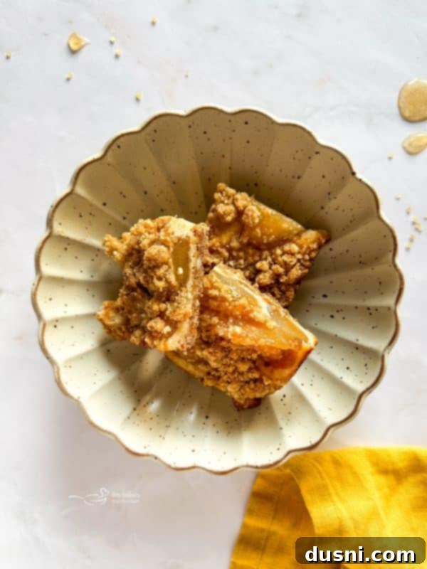 A baking pan filled with golden brown Apple Pie Crumb Bars, ready to be cut