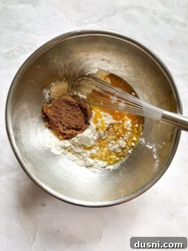 Dry ingredients for the crust being whisked together in a large mixing bowl