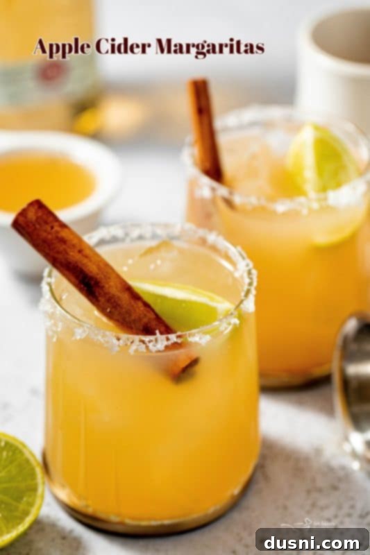 Apple Cider Margarita 15 A stunning hero shot of Apple Cider Margaritas with a cozy fall background.