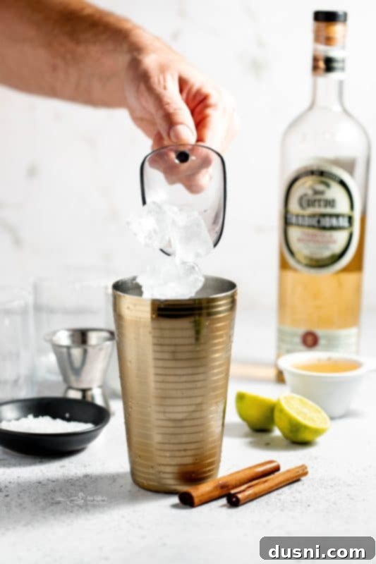 Apple Cider Margarita 7 A glass being pressed into a plate of Maldon salt to create a rim.