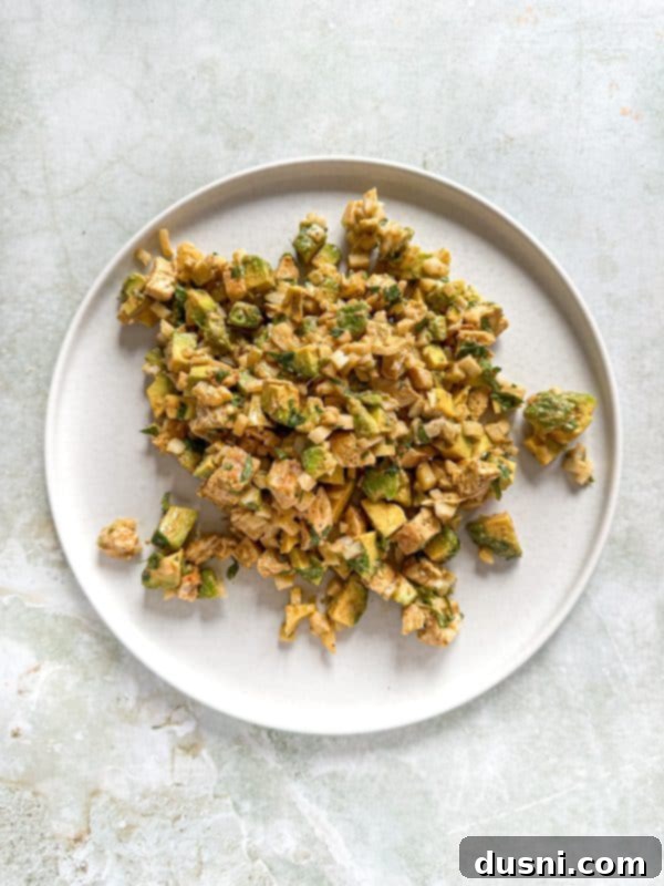 Irresistible Avocado Chicken Salad Dip 11 Avocado Chicken Salad Dip in a bowl with a serving spoon.