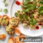 Irresistible Avocado Chicken Salad Dip 19 Close up of Avocado Chicken salad dip and crackers on a white plate.