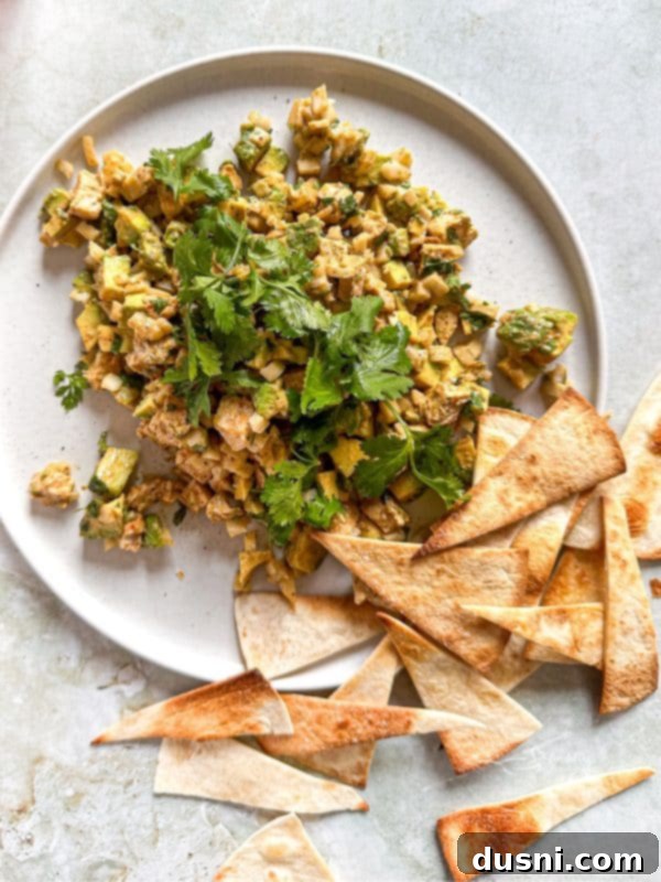 Irresistible Avocado Chicken Salad Dip 3 Avocado Chicken Salad Dip served with crackers on a wooden board