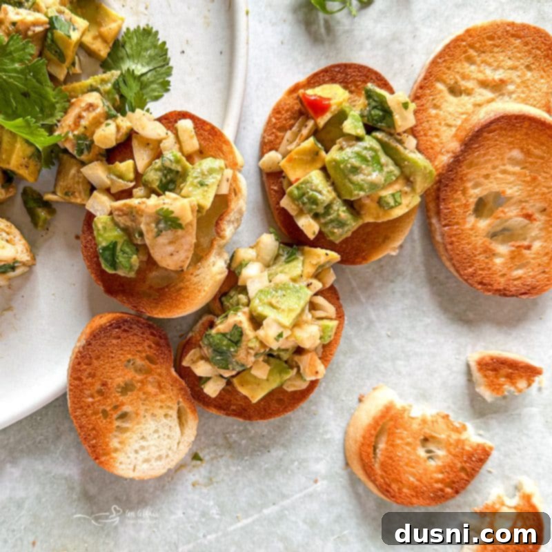 Irresistible Avocado Chicken Salad Dip 6 Avocado chicken salad dip being mixed in a bowl.