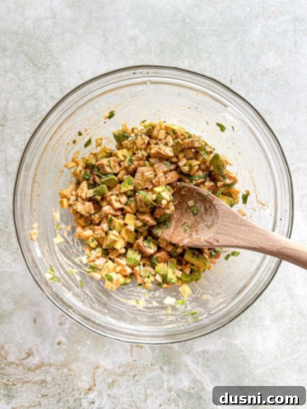 Irresistible Avocado Chicken Salad Dip 9 Mixing the avocado chicken salad dip ingredients together.