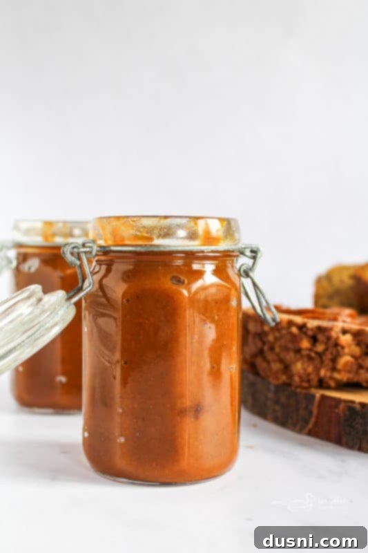A spoonful of creamy homemade pumpkin butter, ready to be enjoyed.