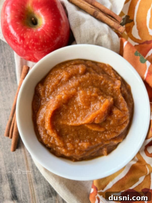 A white bowl filled with Instant Pot Pumpkin Applesauce, a related recipe.
