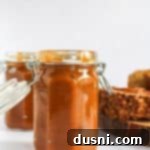 Side view of the pumpkin butter in a mason jar, showcasing its rich color.