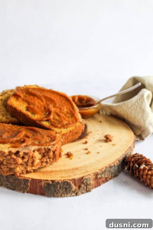 Freshly made pumpkin butter in a glass jar, highlighting its smooth texture.