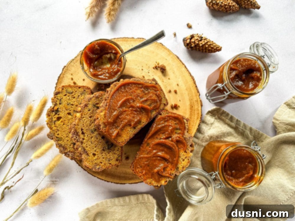 Pumpkin butter mixture simmering gently in a saucepan.
