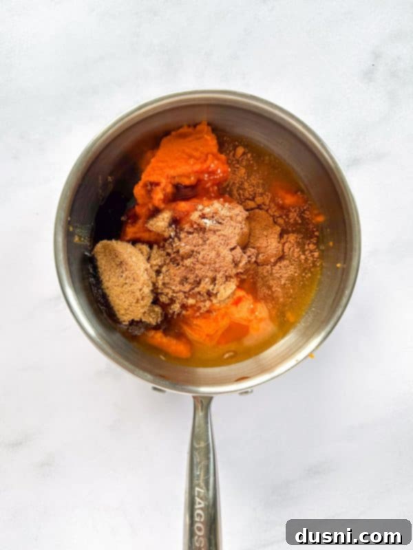 Ingredients for pumpkin butter combined in a saucepan, before cooking.