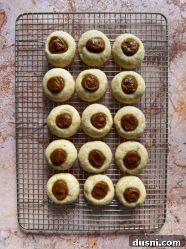 Filling snickerdoodle thumbprint cookies with creamy pumpkin butter.
