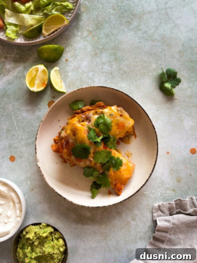 Comforting Slow Cooker Smothered Burritos 10 Close up of melted cheese on Slow Cooker Smothered Burritos.