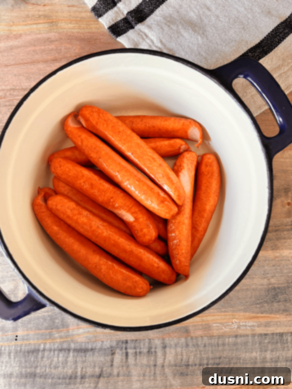 BBQ Hot Dogs and Sauerkraut 6 Step 1: Preheat oven and place wieners in a cast iron Dutch oven.