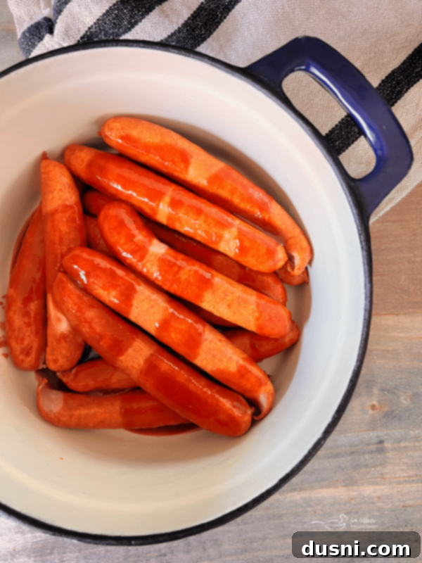 BBQ Hot Dogs and Sauerkraut 7 Step 2: Lay wieners in the bottom of a cast iron Dutch oven.