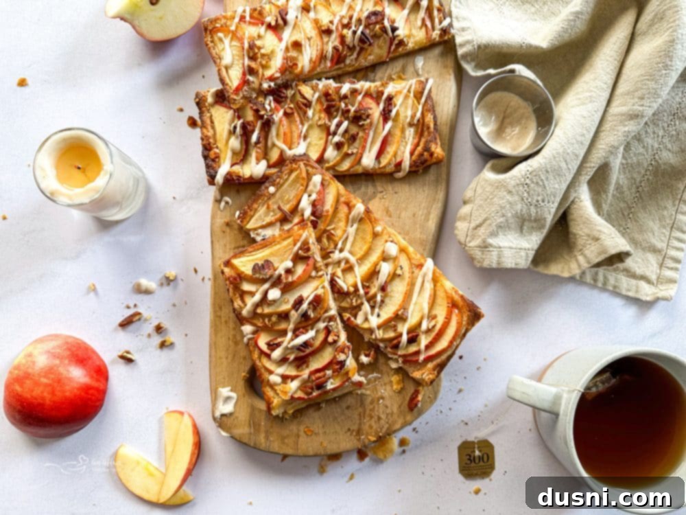 Simple Puff Pastry Apple Tarts 13 Group of Puff Pastry Apple Tarts on a wooden cutting board