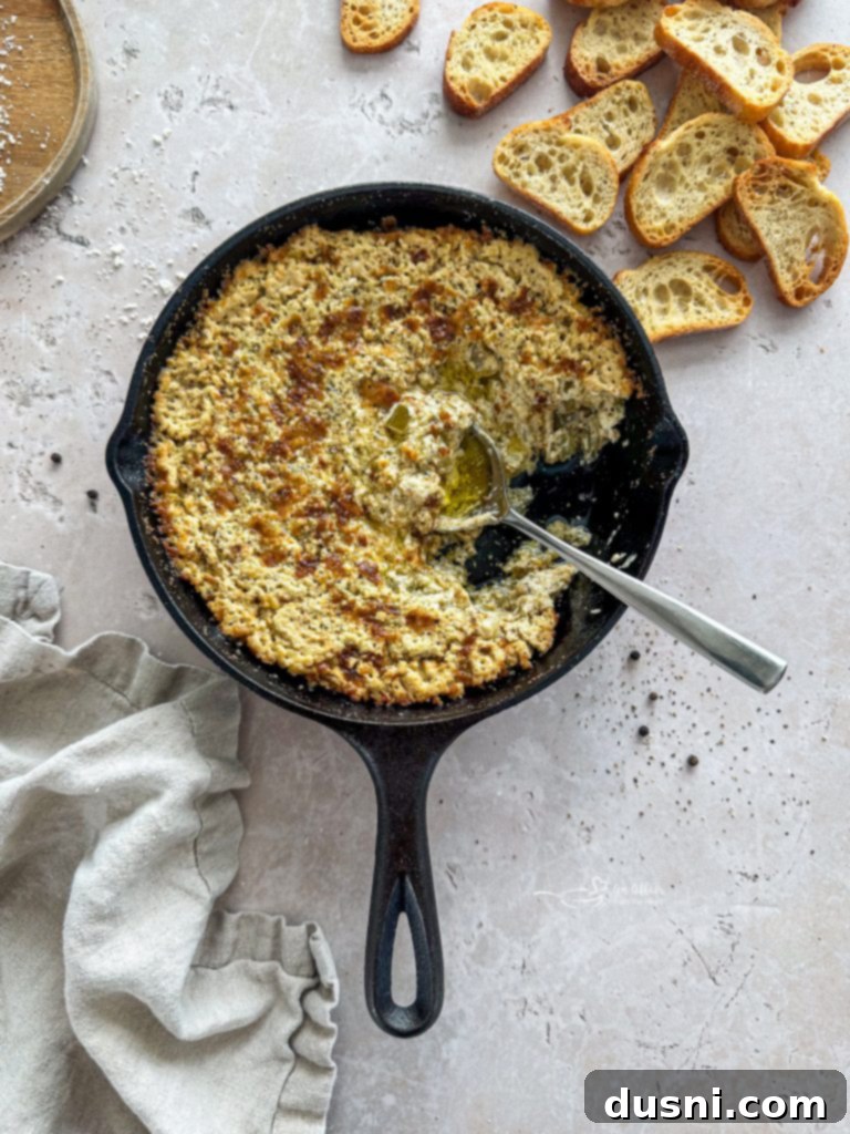 Warm & Bubbly Onion Dip 5 Close-up of baked onion dip in a white baking dish