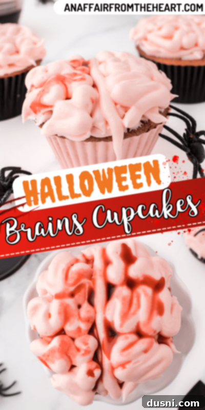 Ghoulish Grey Matter Cupcakes 18 A close-up shot of a Halloween Brain Cupcake with a white background, focusing on the pink brain-shaped frosting and the red edible blood. The clean presentation emphasizes the creative and spooky details of this Halloween dessert.