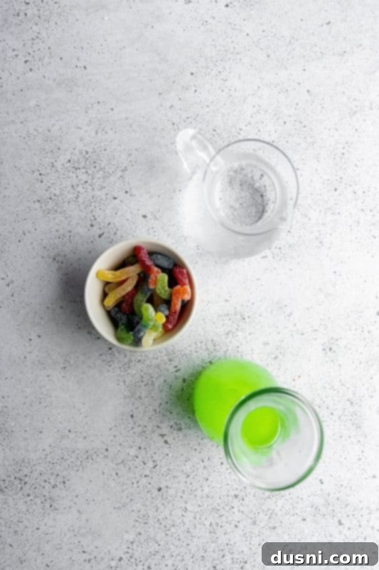 Mixing Kids Halloween Punch in a pitcher